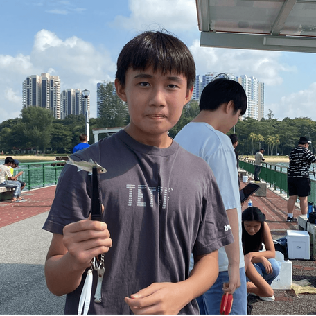 Pic of one of a student attending our fishing classes and is very satisfied with our services. Wondering what he is using to hold the fish? 
